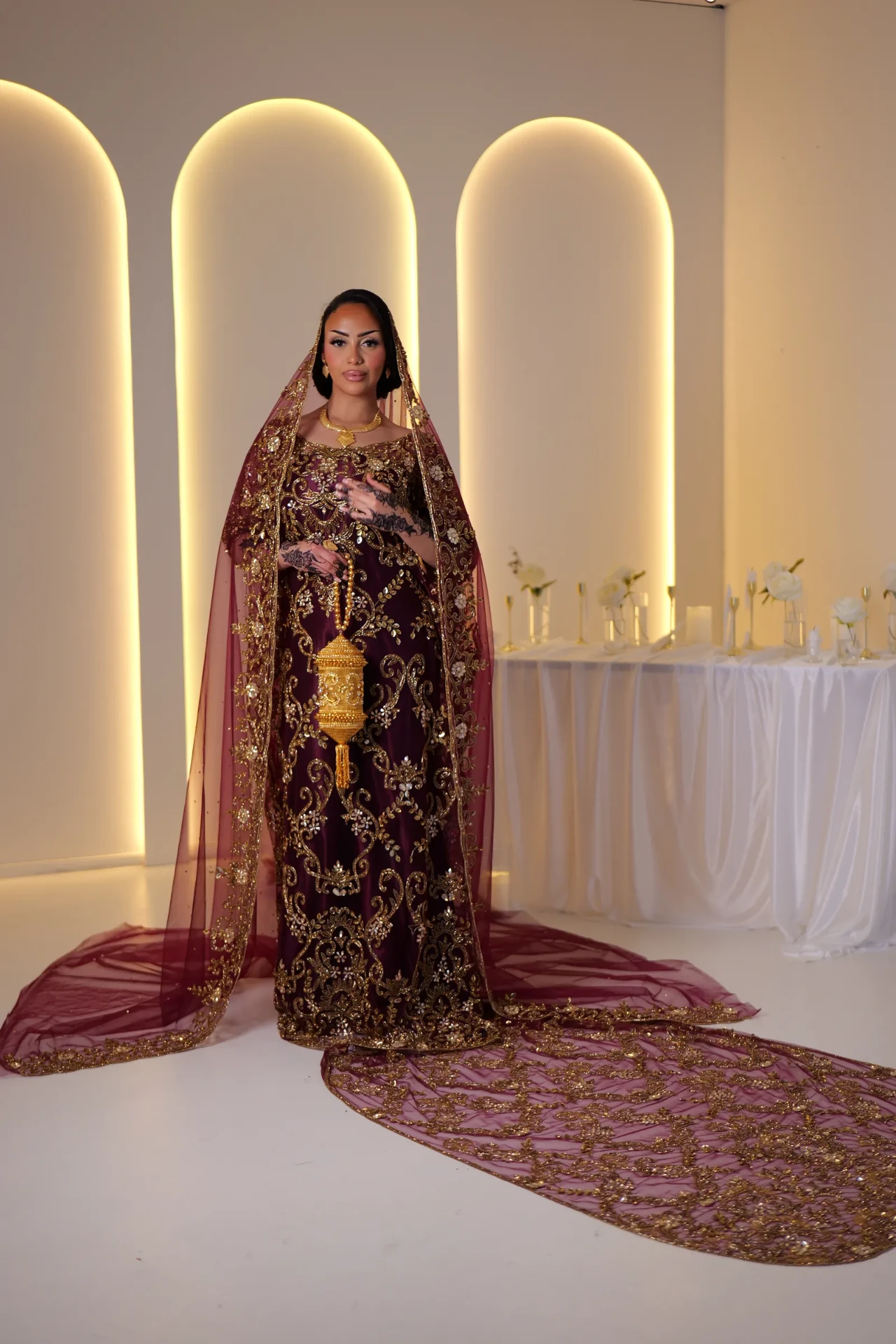 Full-length wine dirac with gold embroidery and a long burgundy train